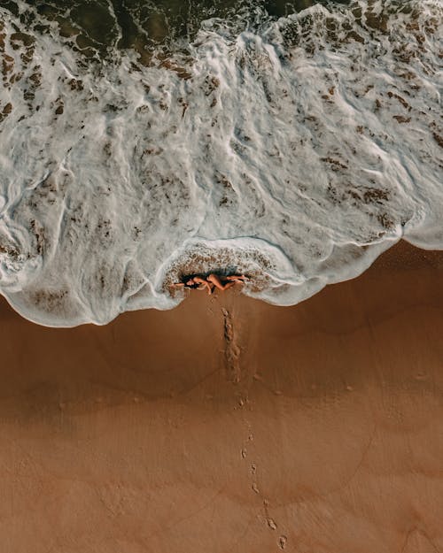 A Woman in a Swimsuit Lying on the Shore