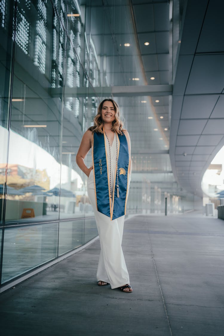 Woman With A Sash Standing On A Walkway