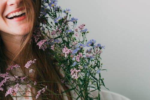 Free Smiling Woman Holding Flowers Stock Photo