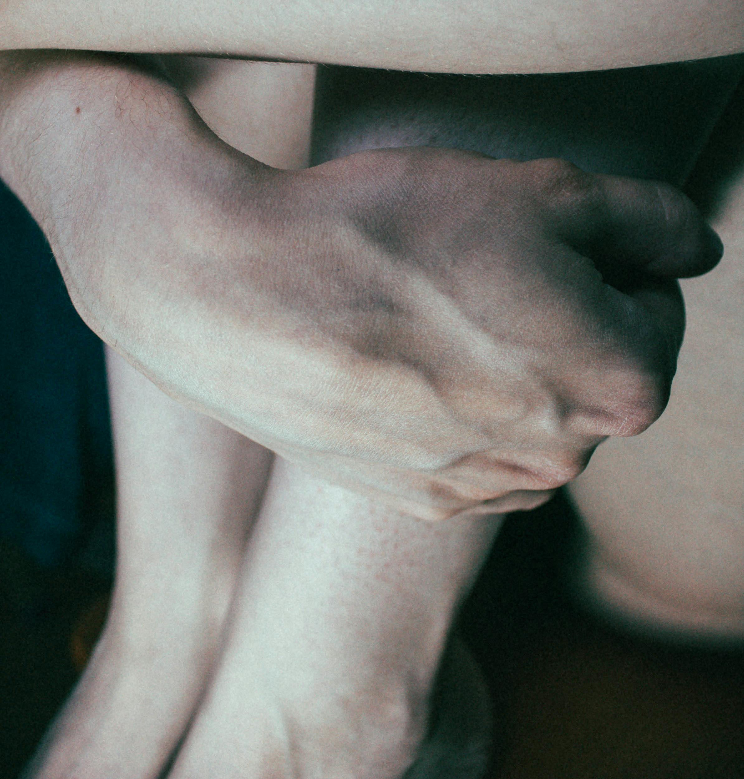 close up of a person holding their legs