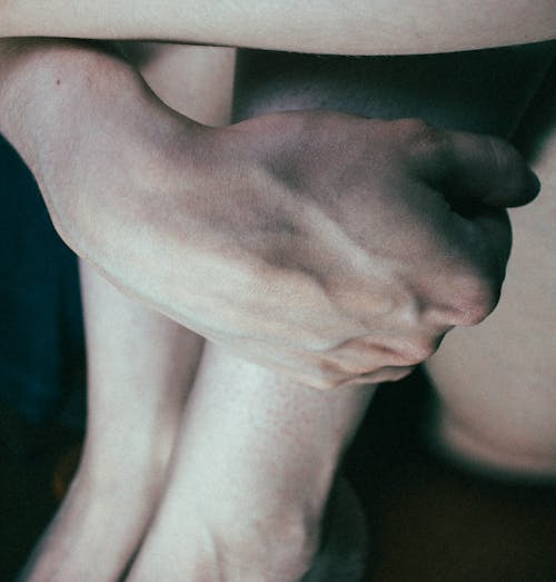 Close up of a Person Holding their Legs