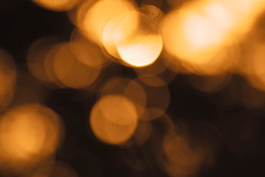 A captivating abstract image showcasing golden bokeh lights creating a dreamy, blurred effect.