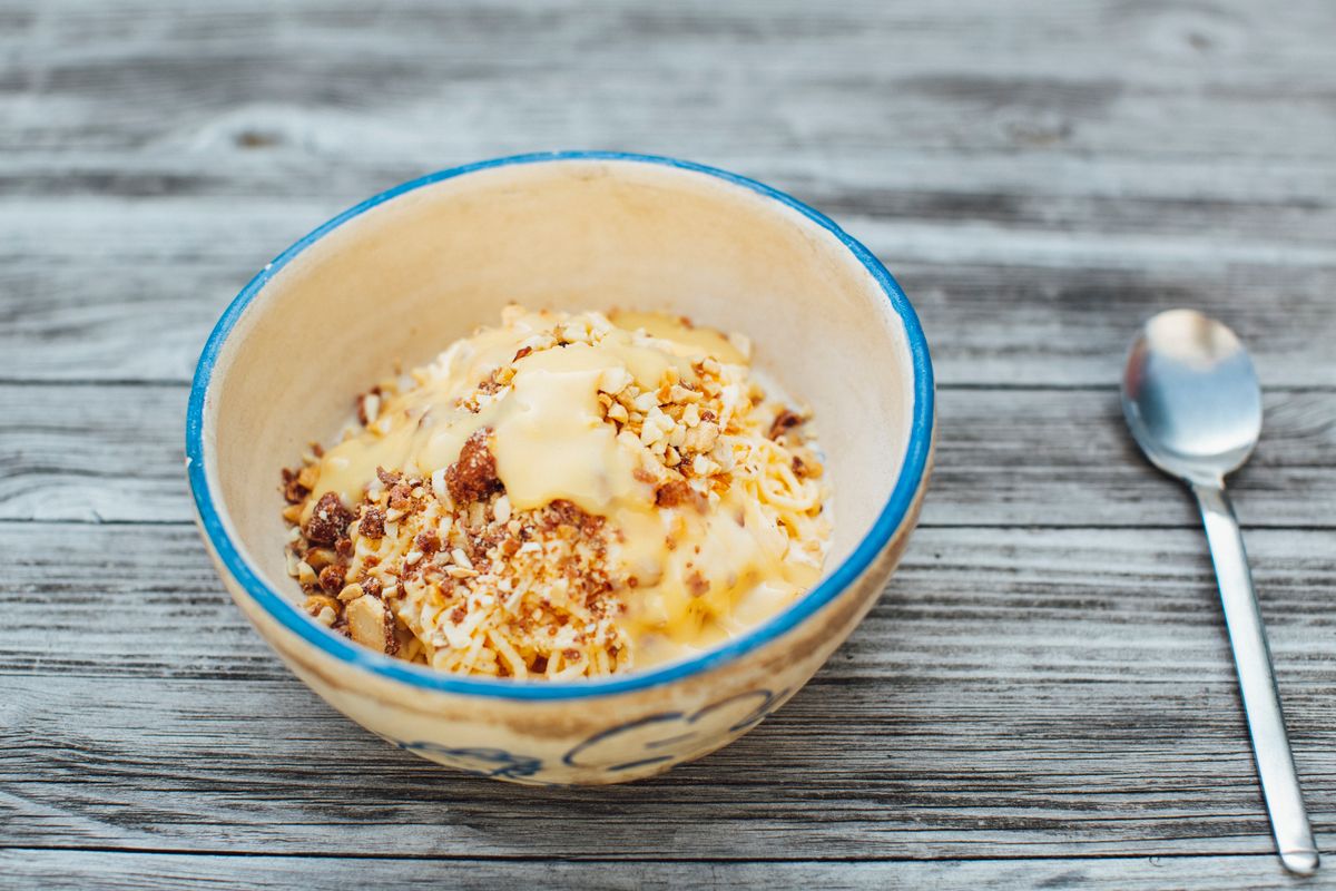 Traditional Kheer rice pudding in a rustic bowl garnished with saffron