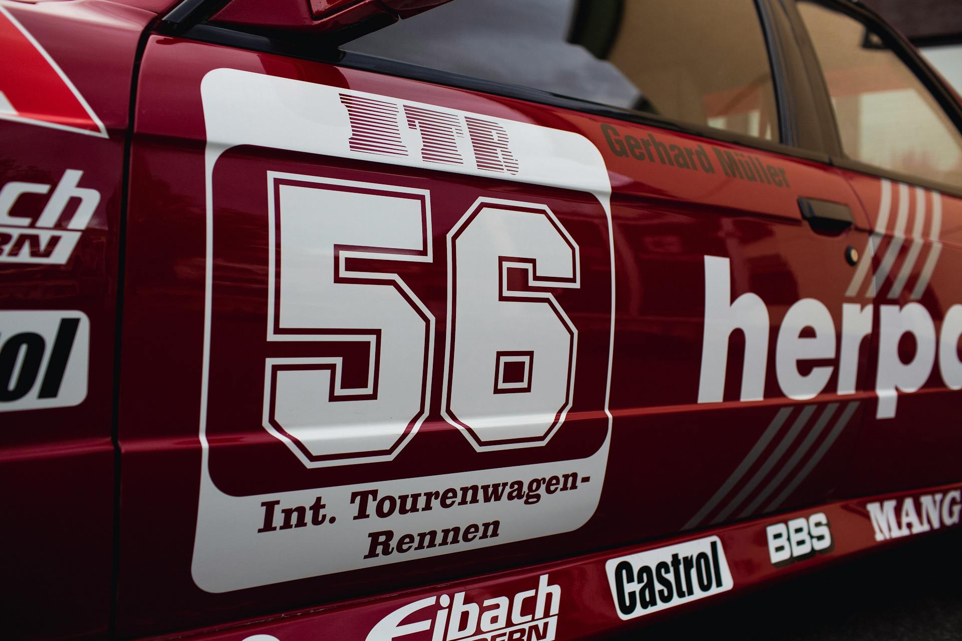 Detailed view of a racing car featuring number 56 with sponsor logos.