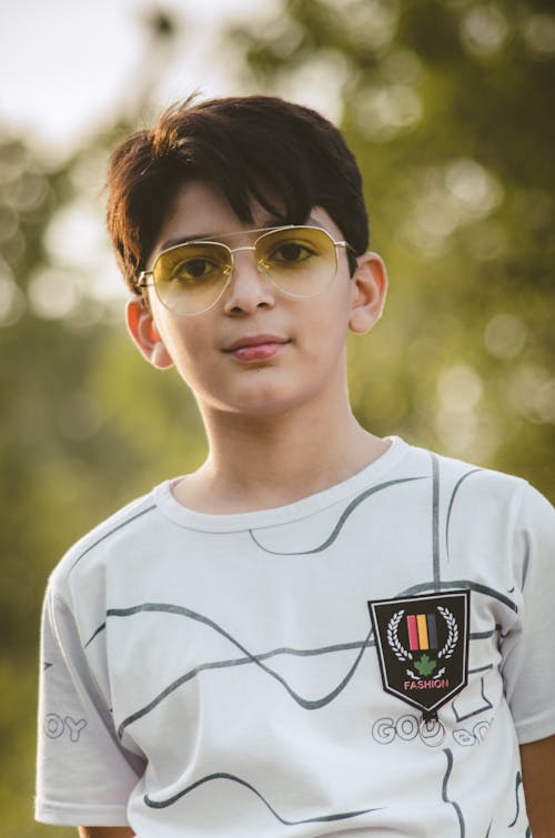 Boy in a White Shirt Wearing Sunglasses