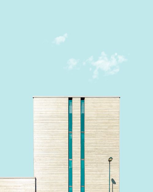Free Minimalist facade of modern building in Sandnes against a clear blue sky with clouds. Stock Photo