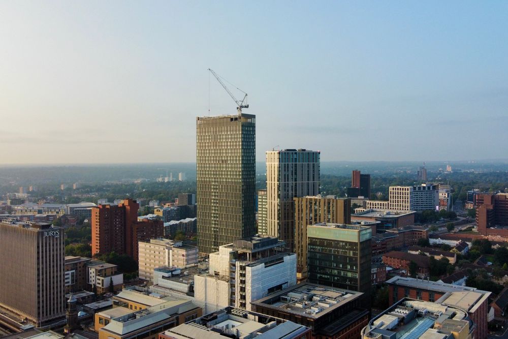 Aerial shot capturing the modern skyline of Birmingham, England during the day.