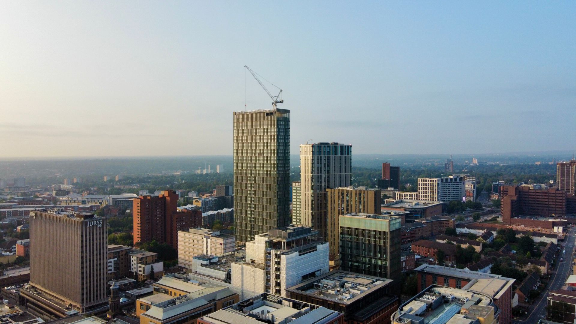 Aerial shot capturing the modern skyline of Birmingham, England during the day.
