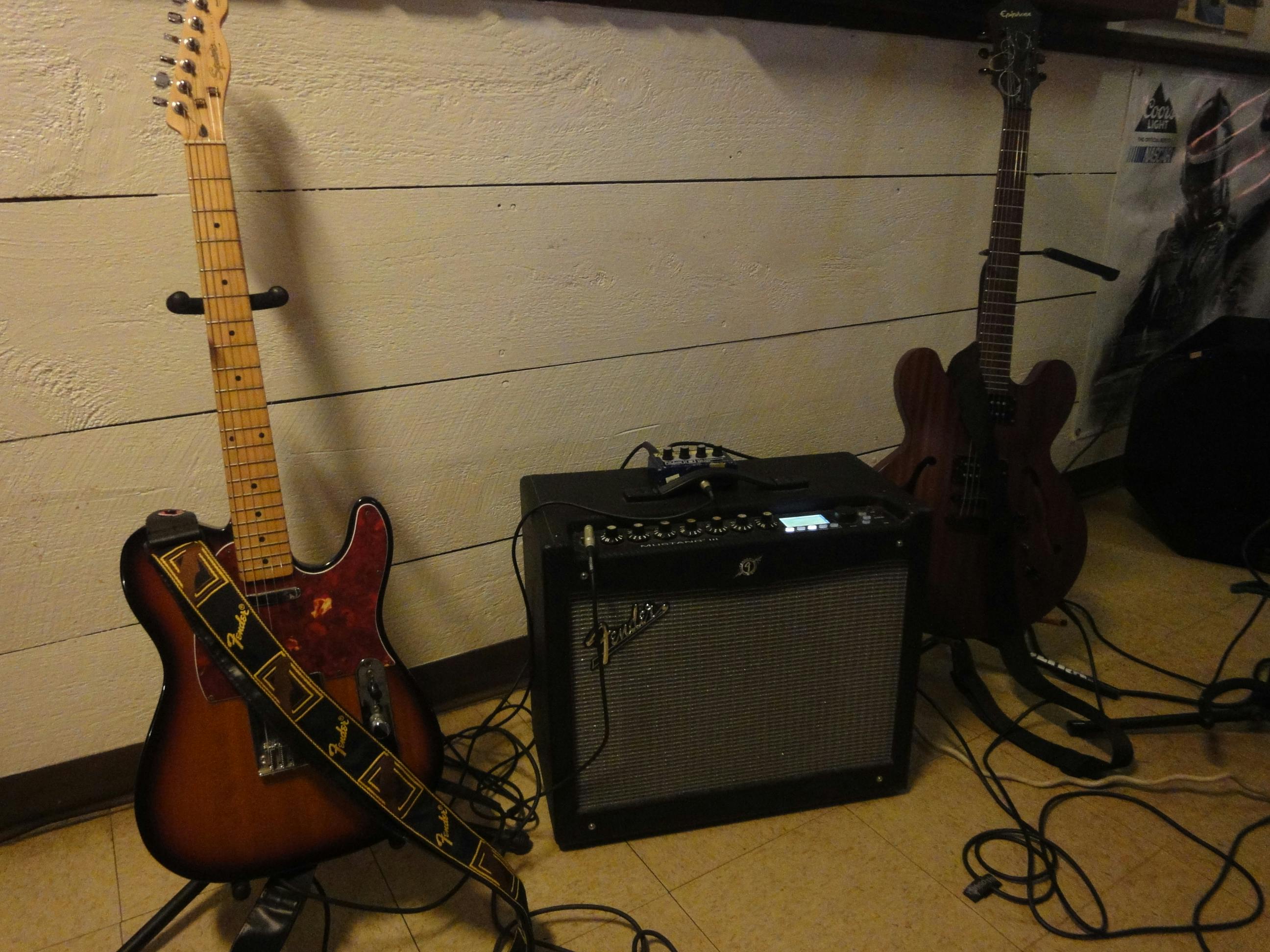 Free stock photo of two guitars and an amp