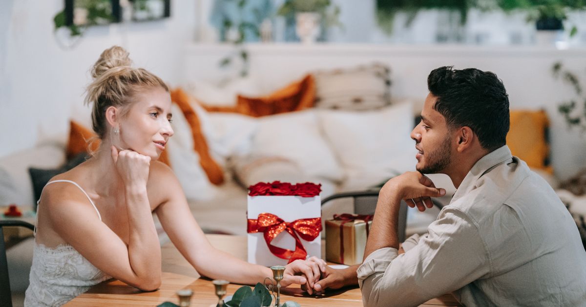 Couple exchanging gifts in a cozy setting