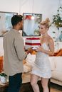 Man in Gray Dress Shirt Holding Woman in White Dress