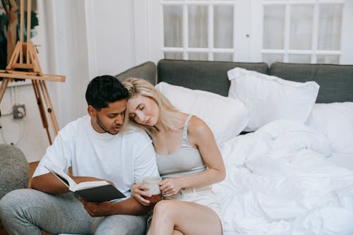 Free Man and Woman Sitting on Couch Stock Photo