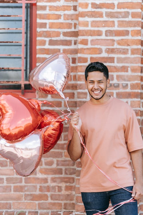 Free Man Smiling While Holding Balloons Stock Photo