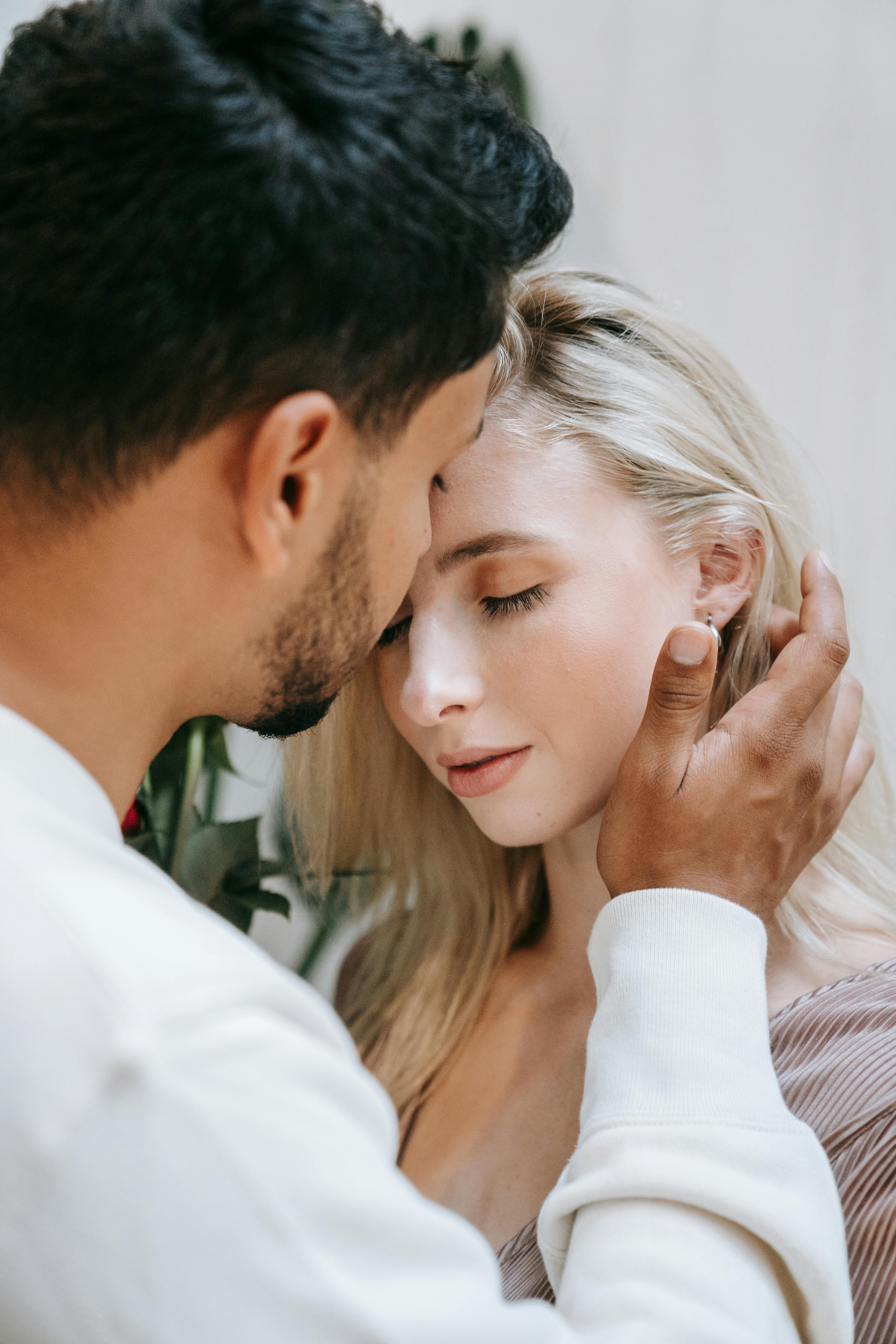 A loving and intimate moment captured between a couple with a warm embrace.