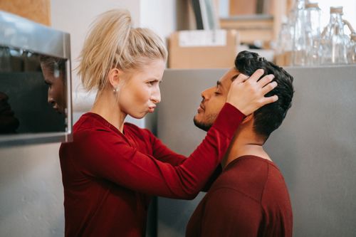Free A playful couple shares a tender moment in a cozy indoor setting, showcasing love and affection. Stock Photo