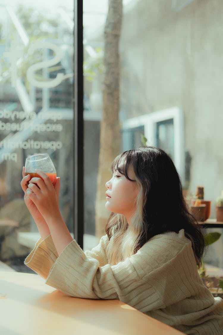 Woman Sitting And Holding Glass