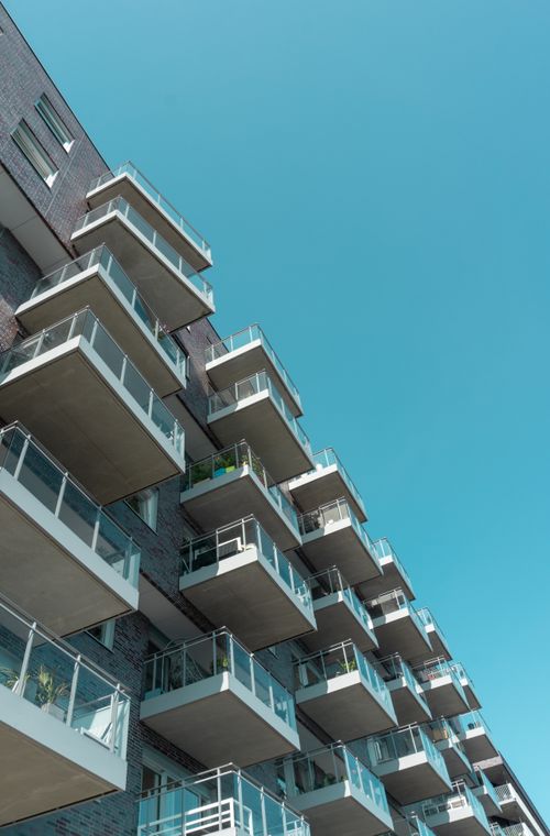 Free Low-angle view of modern apartment balconies in Oslo against a clear blue sky. Stock Photo