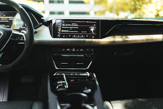 Luxurious car interior featuring a sleek digital infotainment display and modern design.