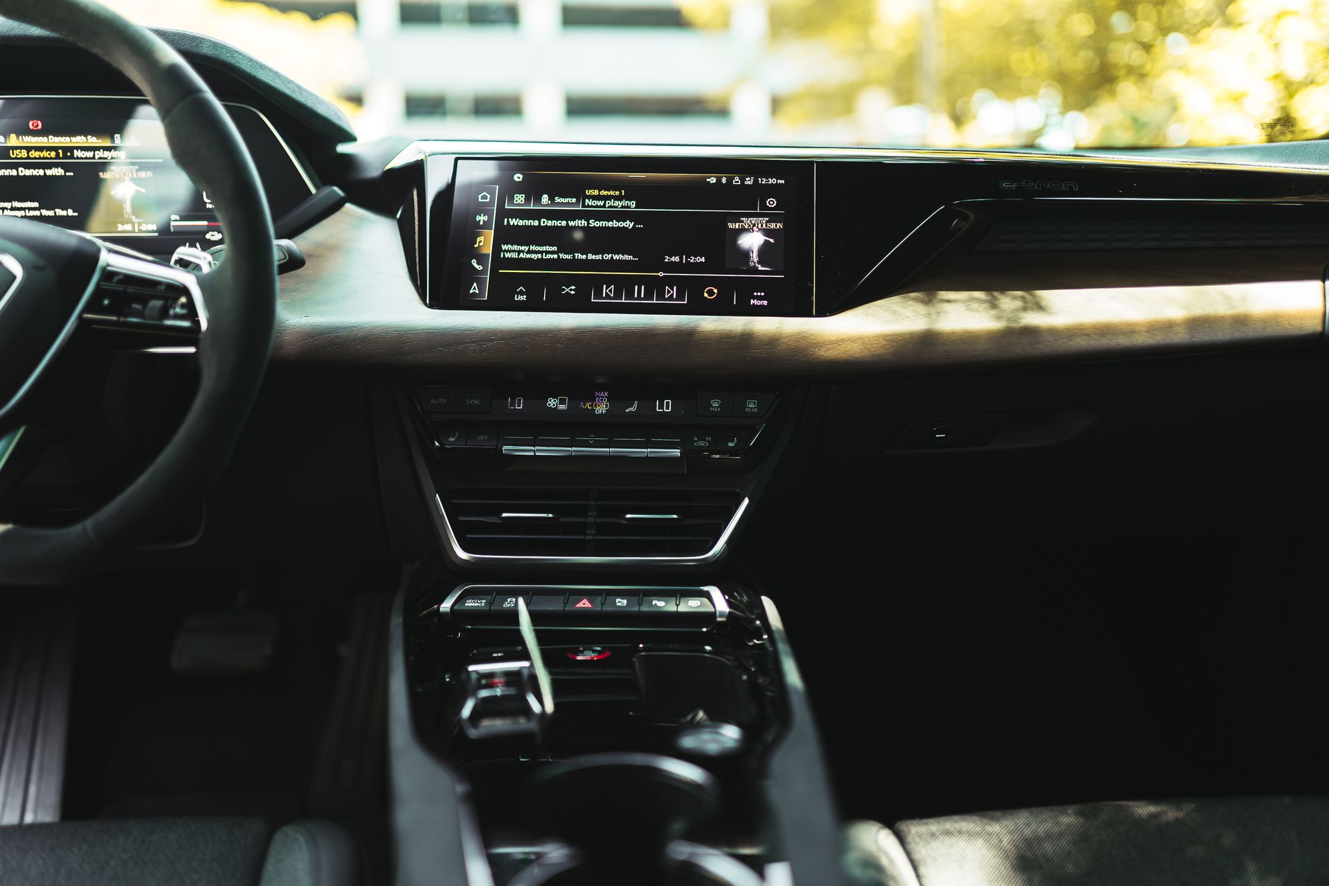 Luxurious car interior featuring a sleek digital infotainment display and modern design.