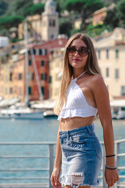 Woman in White Crop Top and Denim Skirt 