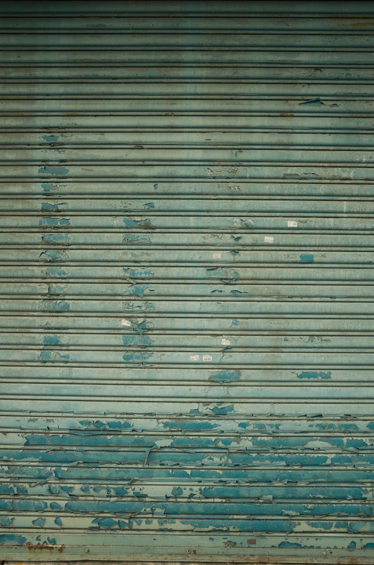 Paint Peeling Off A Green Metal Shutter