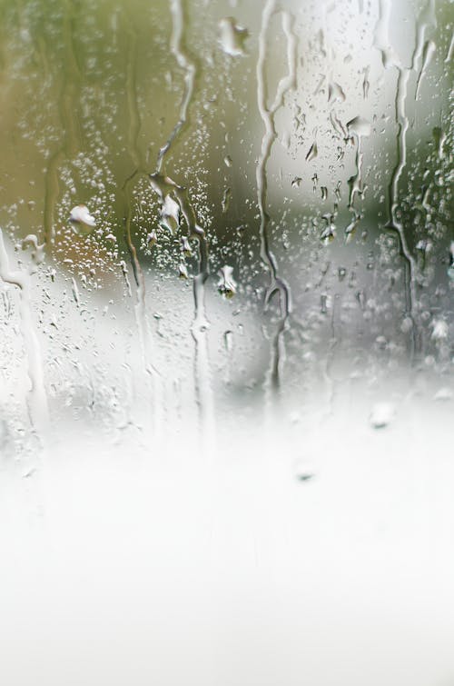 Free Water Droplets on a Misty Glass Window Stock Photo