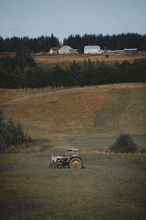Gray Tractor on the Grass Field