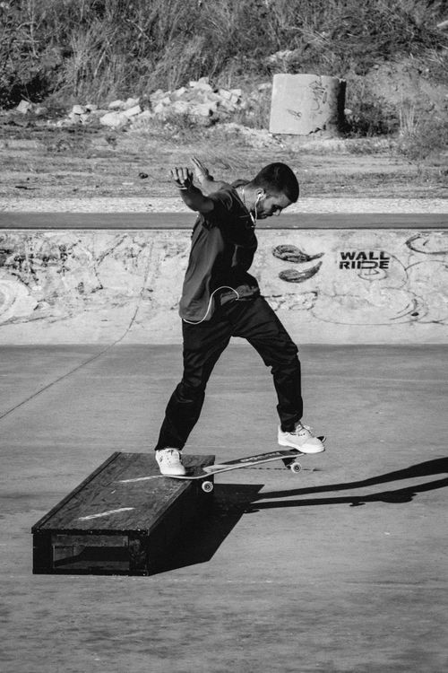 Monochrome skateboarder mid-trick &mdash; photo by Yuri Barreto on Pexels