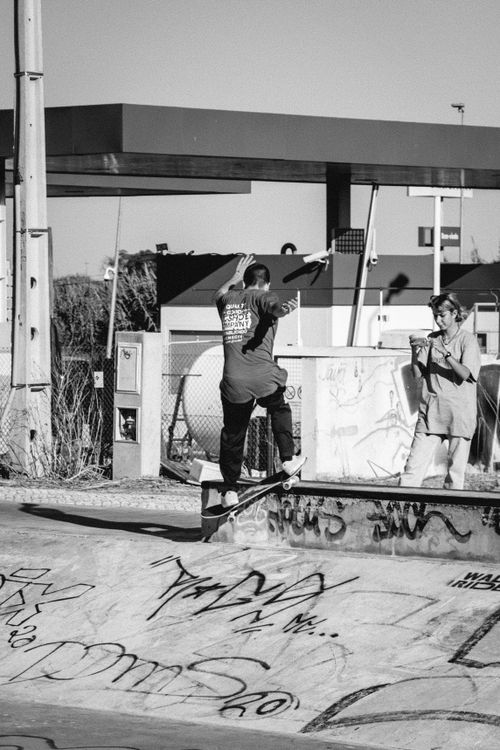 Free Black-and-white photo of a skateboarder performing a trick in an urban skate park. Stock Photo