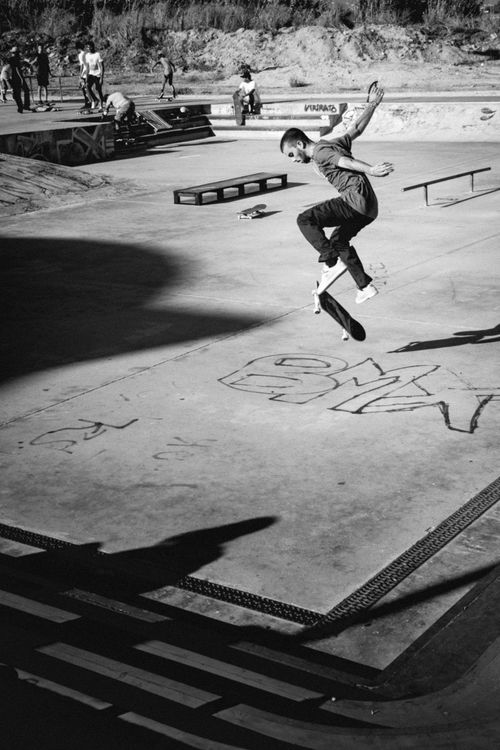 Free Black and white photo of a skateboarder executing a trick at Faro skate park in Portugal. Stock Photo