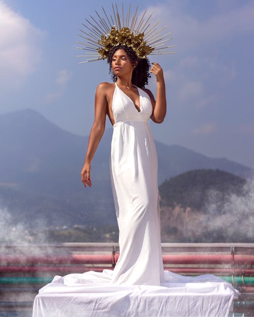 Woman in White Sleeveless Dress Standing on Seashore