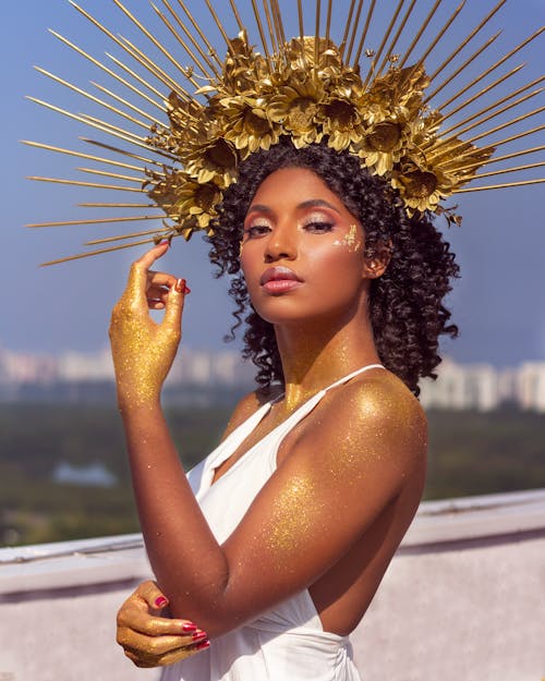 Woman Wearing a Gold Headpiece