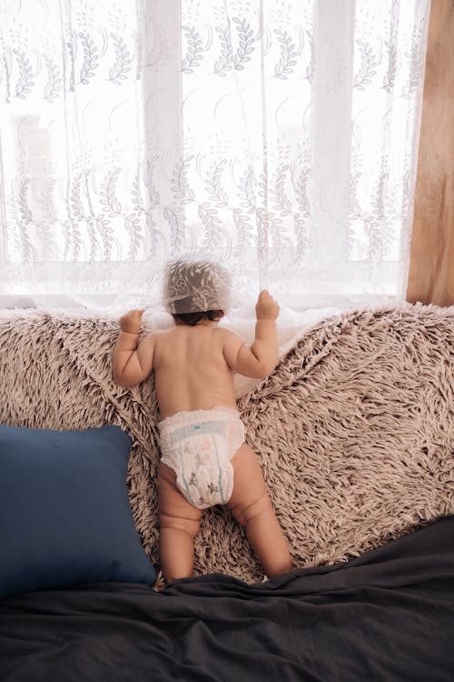Free Adorable Baby on the Couch Stock Photo