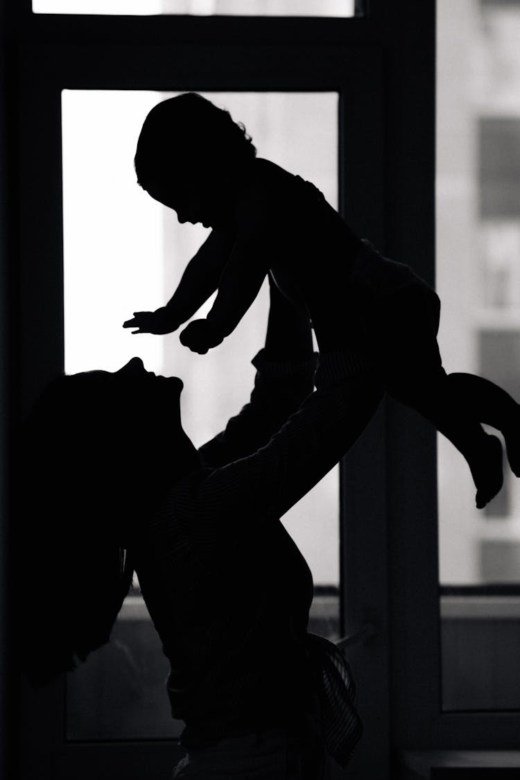 Silhouette Of A Woman Carrying Her Baby