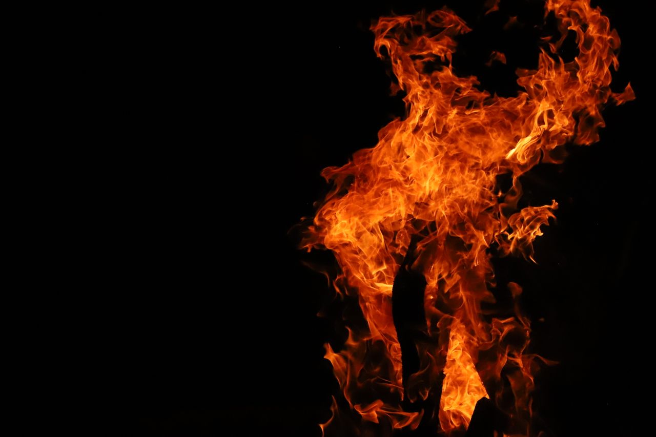 vivid flames rising in darkness exuding heat and vibrant energy