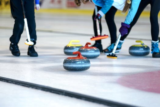 Dynamic game of curling with players sweeping stones on an ice rink.