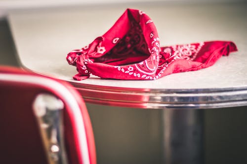 Free Red Paisley Handkerchief on Gray and White Table Stock Photo
