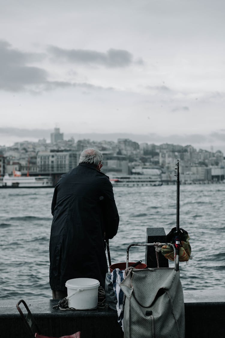 A Man Fishing In A City