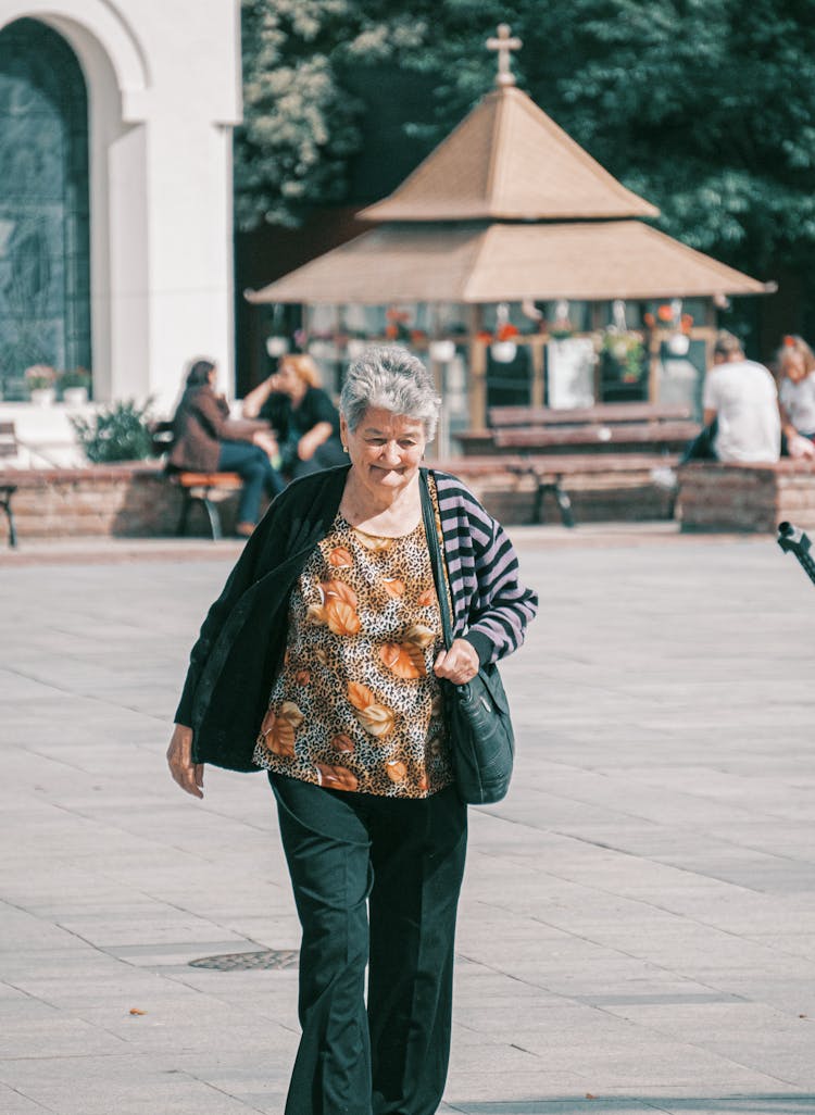 A Woman Walking In A City