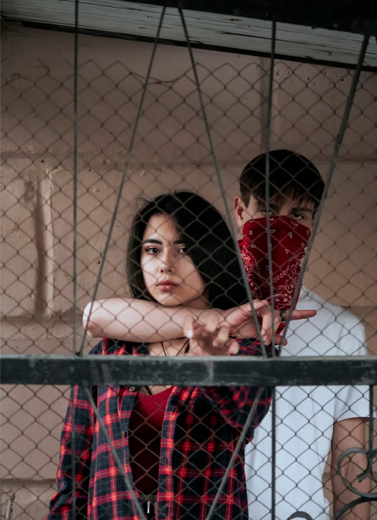 Woman And Man Posing Behind Net