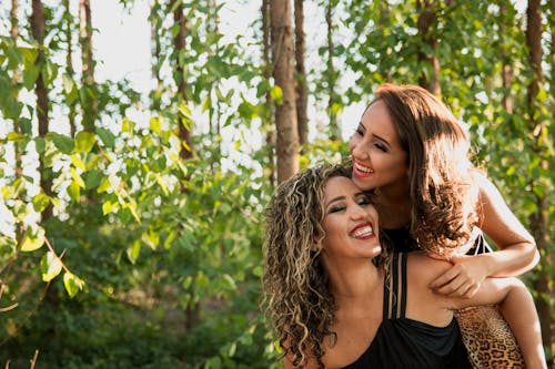 Free Woman Wearing Black Camisole Beside Woman in Black Dress Stock Photo