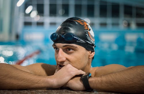 Man Wearing Swimming Goggles and Cap 