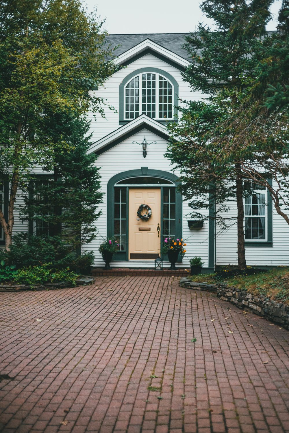Bright home exterior with a spotless brick walkway