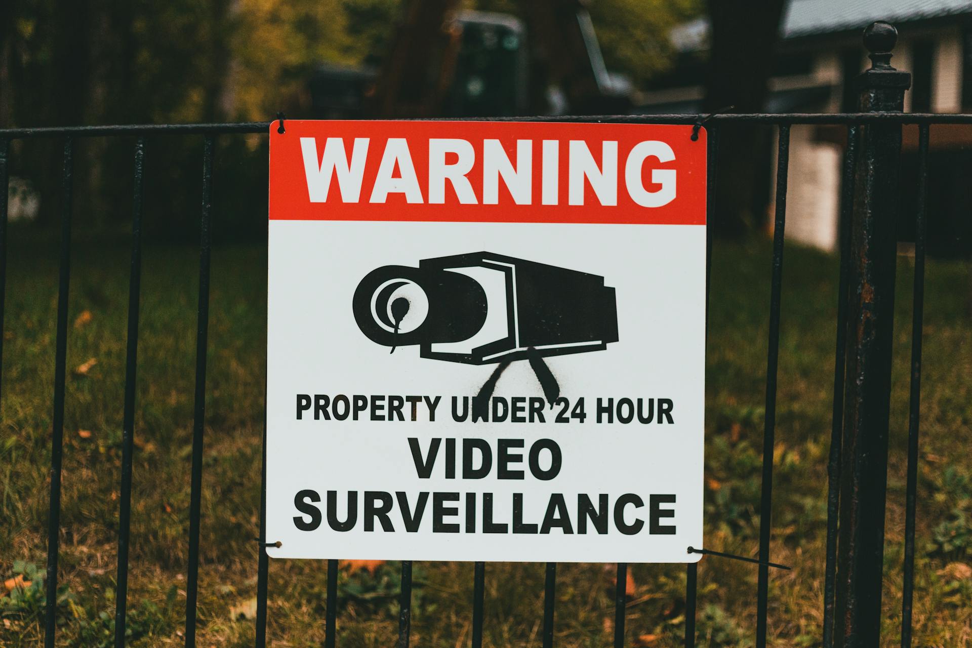 Warning Sign on a Metal Fence