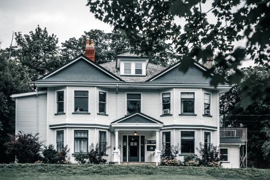 Charming Victorian-style home with an inviting front yard and classic architectural details.
