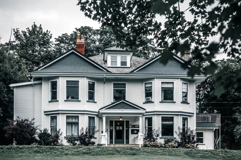 Luxury Dexter home exterior behind a client testimonial