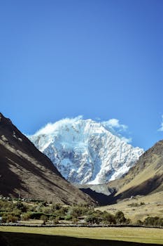 Snow-capped peak in the Andes, Cuzco, Peru offers a breathtaking view of nature's splendor.