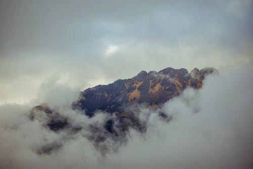 Free Brown Mountain covered in Clouds Stock Photo
