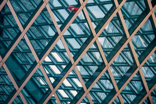 Detailed view of a modern geometric glass ceiling with intersecting lines.