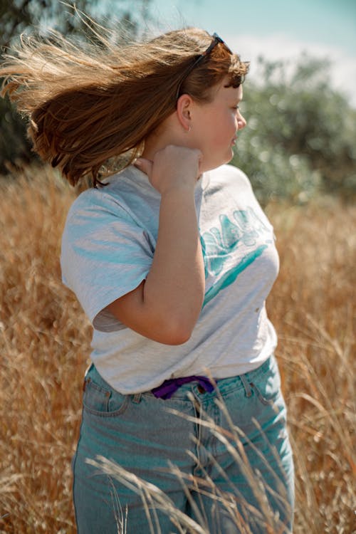 Teenager in Jeans and Tshirt Posing in Field